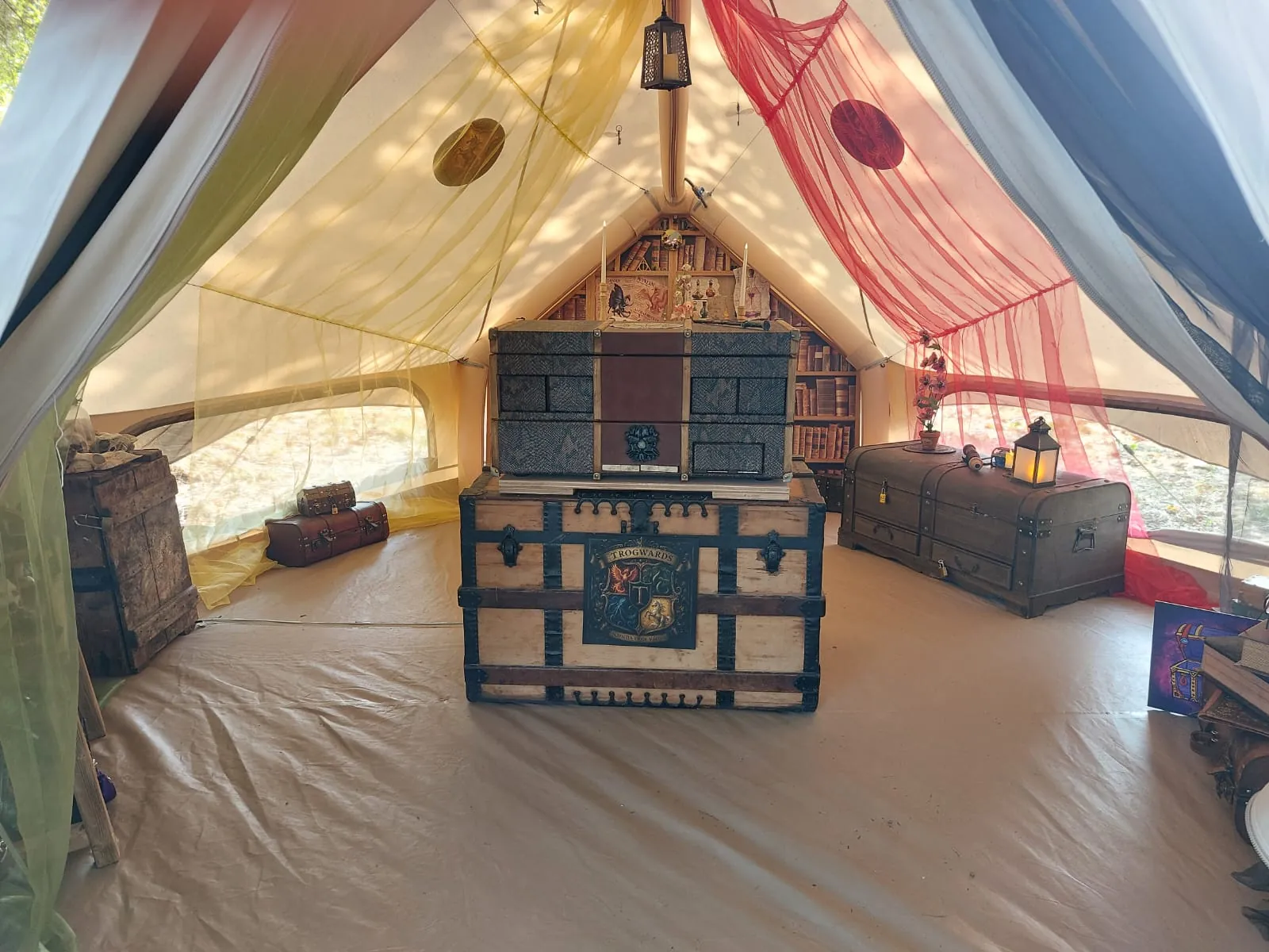 Het decor binnen in de tent van School of Magic XL, met kasten, kisten en lantaarns.